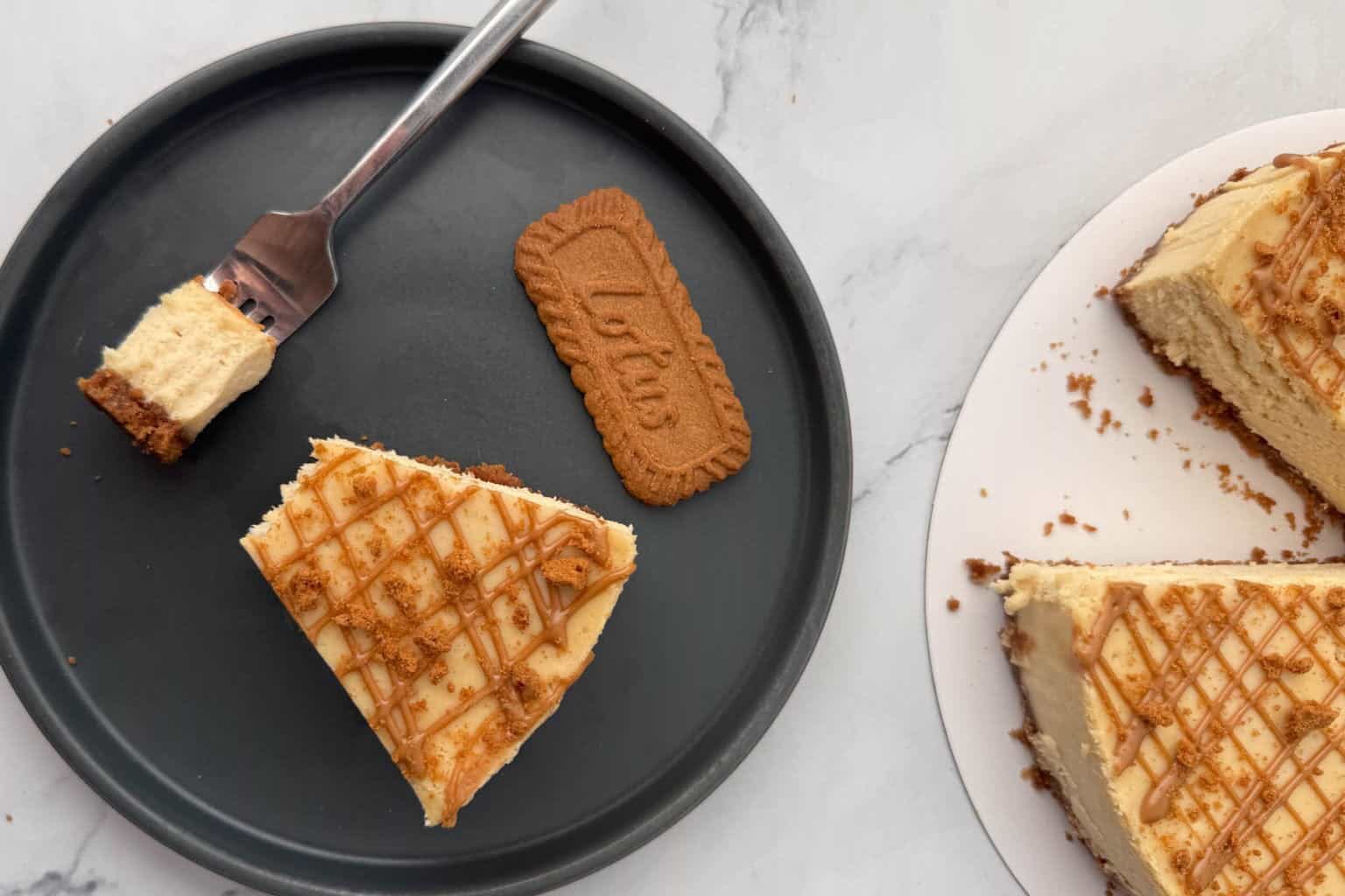 A plate of a slice of Biscoff Cookie Butter Cheesecake,
