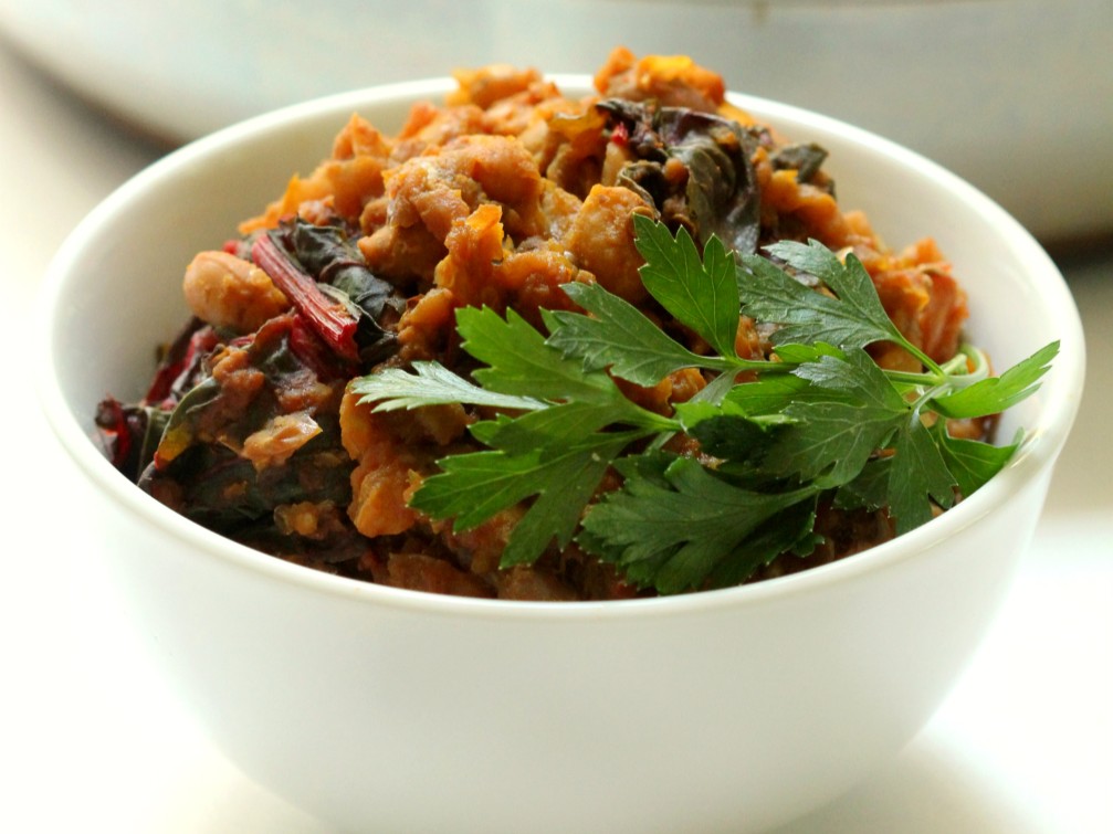 A bowl of Black Eyed Pea Curry with Swiss Chard & Roasted Eggplant