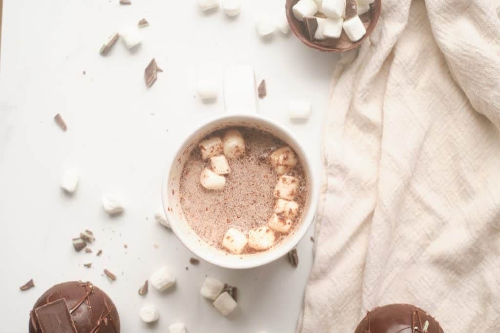 A mug with a melted Mocha Mint Hot Cocoa Bomb.