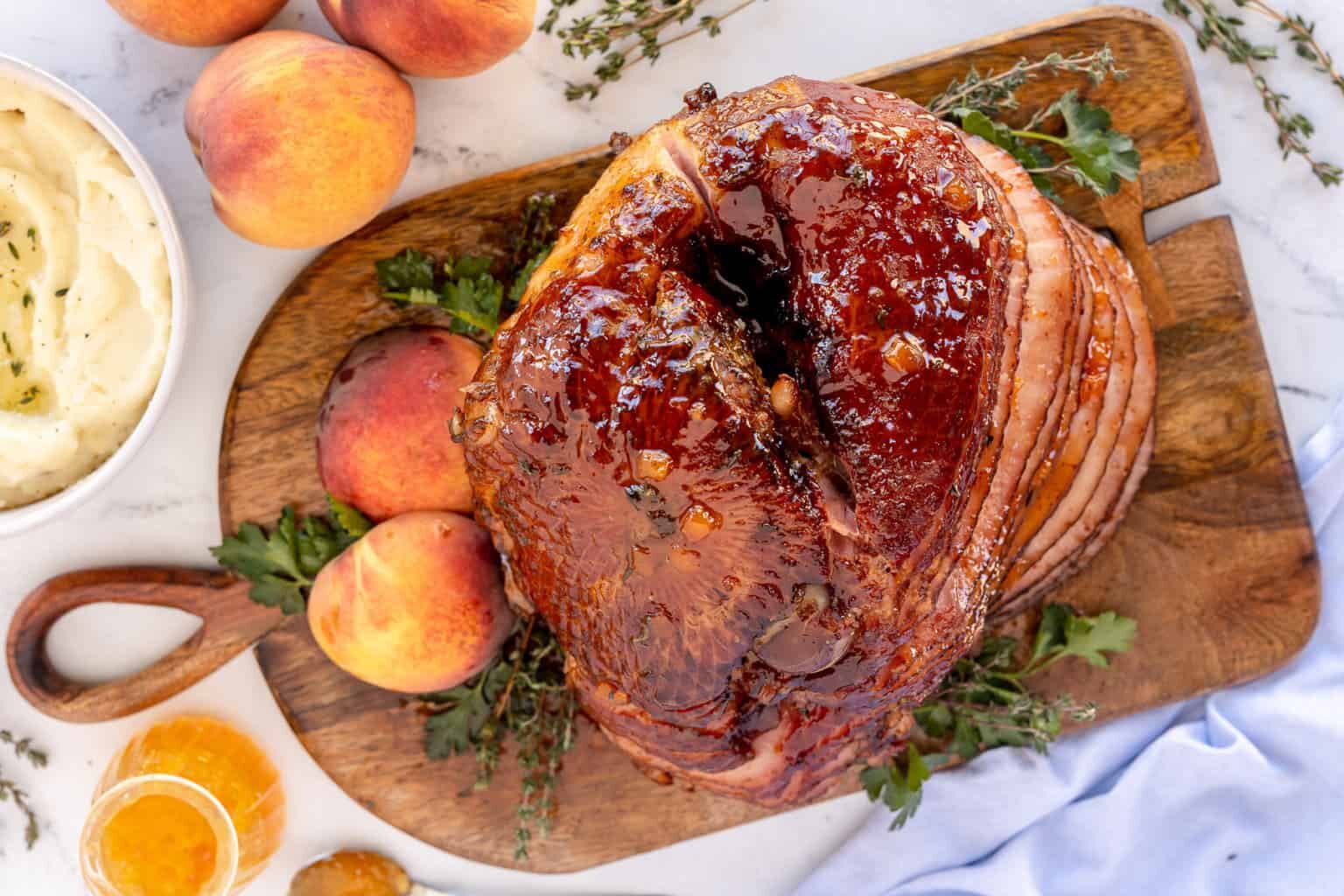 An overhead shot of Slow Cooker Ham with Peach Thyme Glaze on a wooden tray