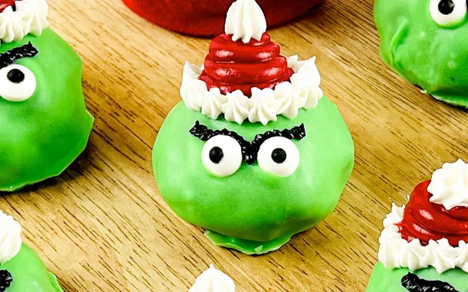 A close up shot of a Grinch Oreo Ball.