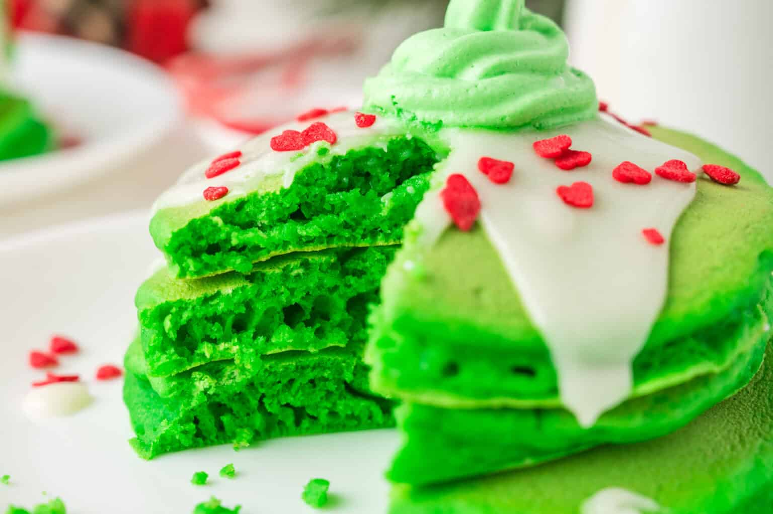 A close up shot of stacked green Grinch Pancakes