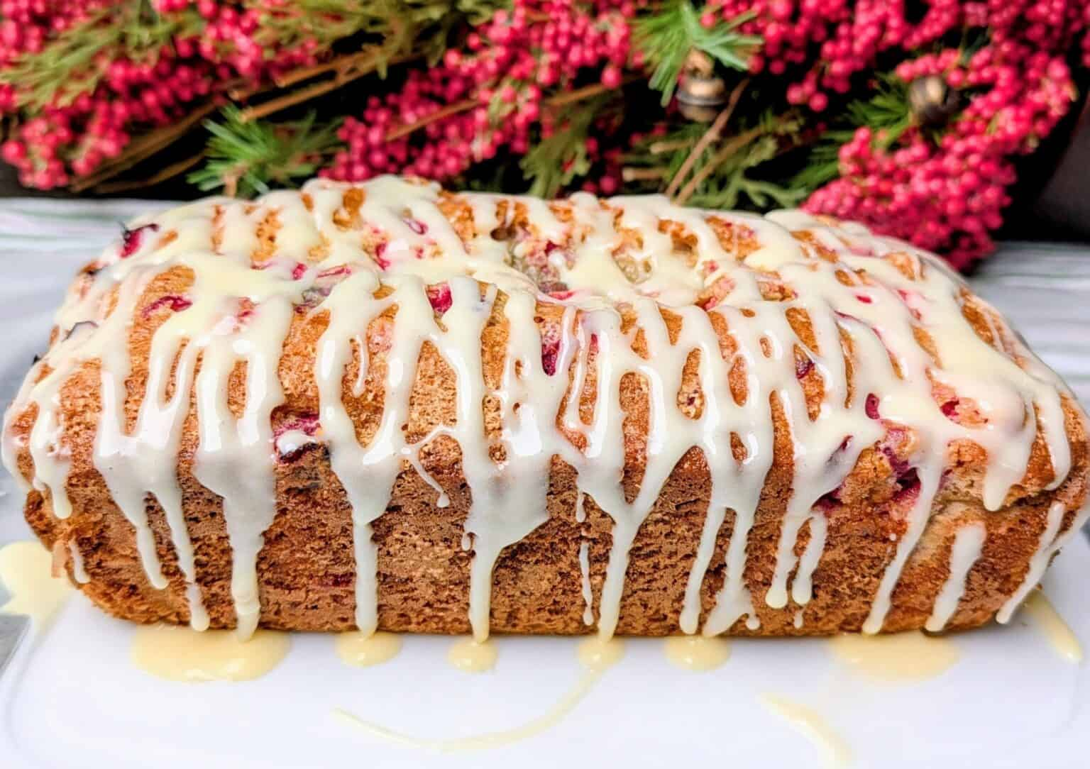 A loaf of drizzled Cranberry Eggnog Bread