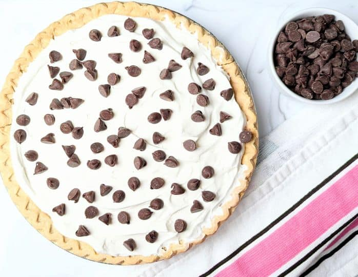 An overhead shot of French Silk Pie with a small bowl of chocolate chips on the side.