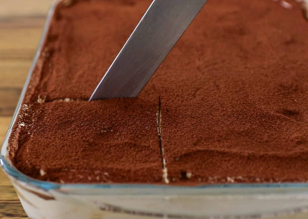 A knife cutting through Italian Tiramisu