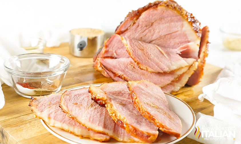 A cut up Baked Maple Glazed Ham on a plate.