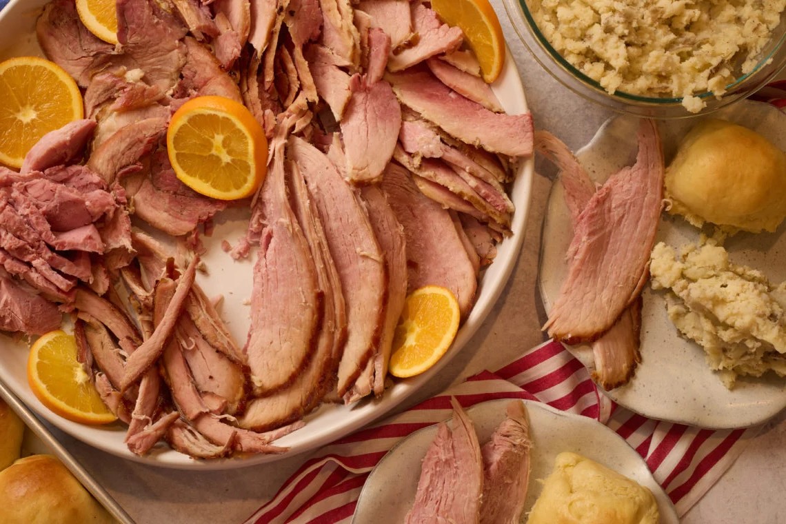 A platter of cut Holiday Maple-Orange Baked Ham
