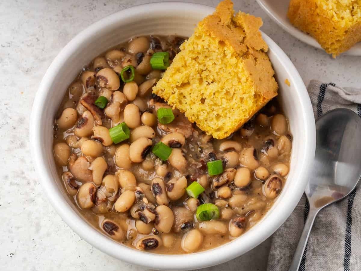 A bowl of Southern Style Black Eyed Peas with cornbread on the side