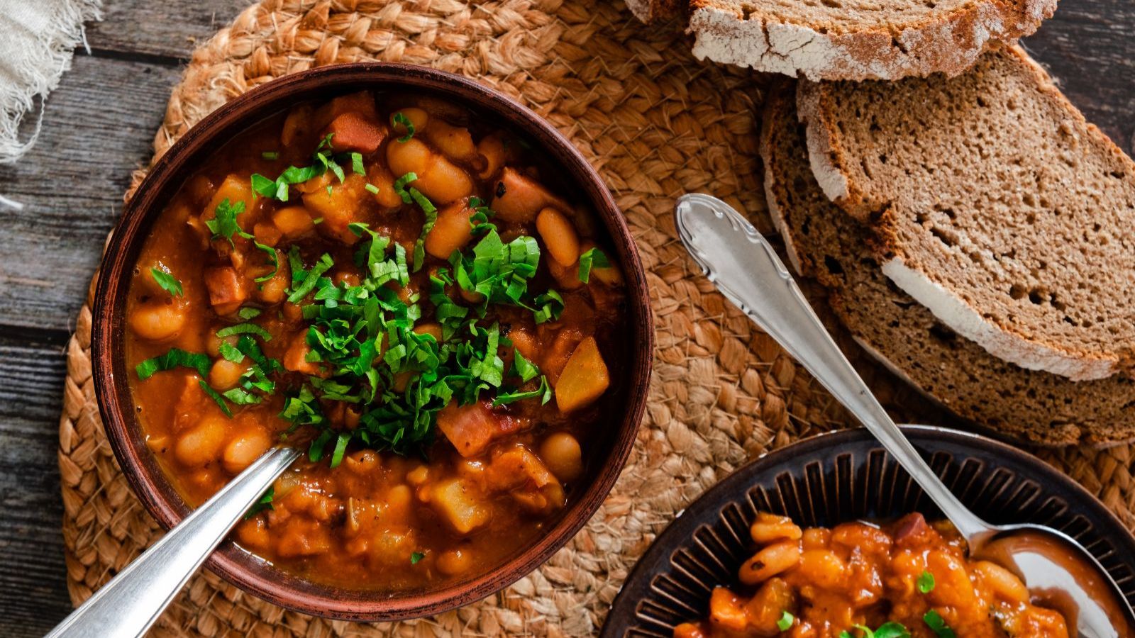 Soup with beans and sliced bread.