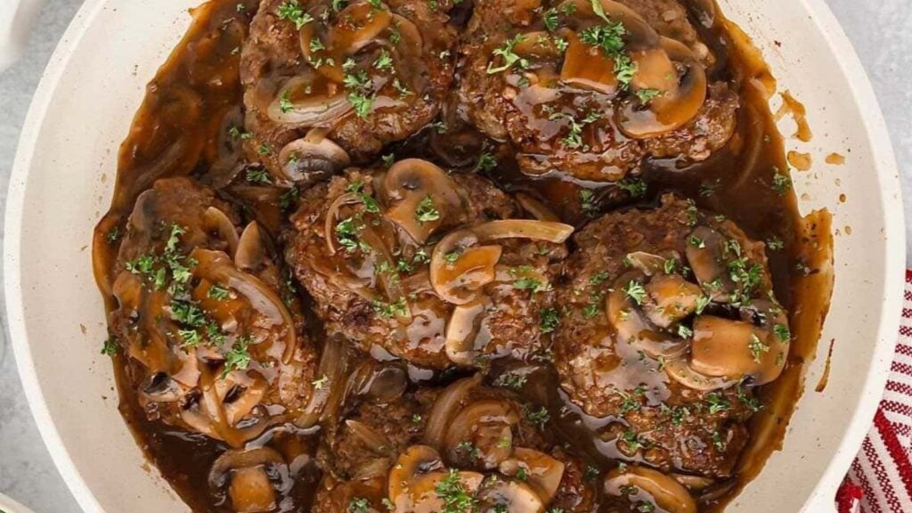 Salisbury Steak in a pan.
