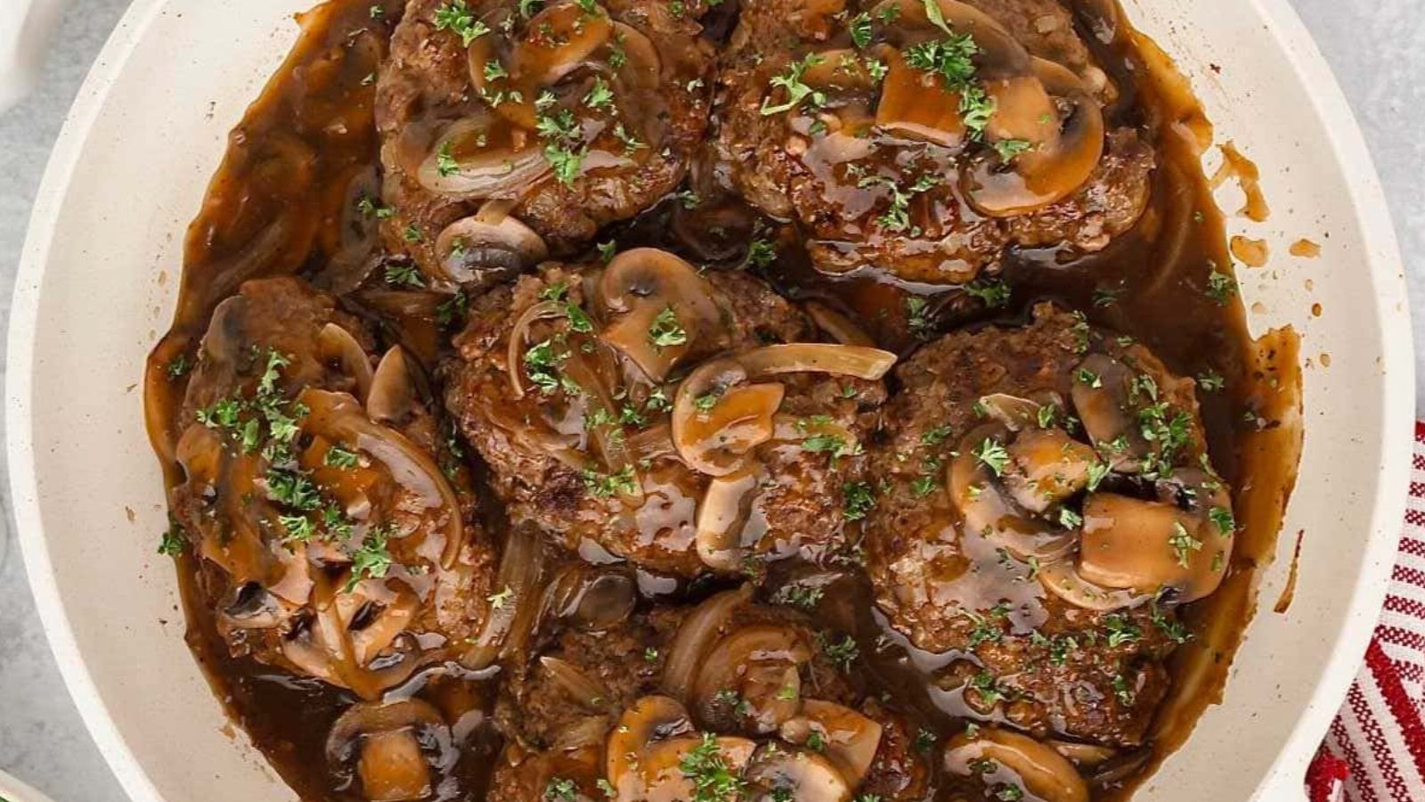 Salisbury Steak in a pan.
