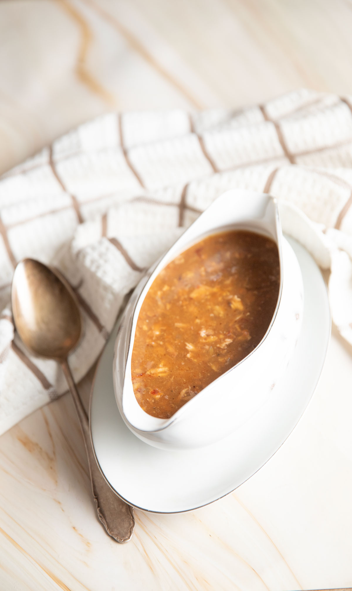 Brown turkey gravy in a white gravy boat.