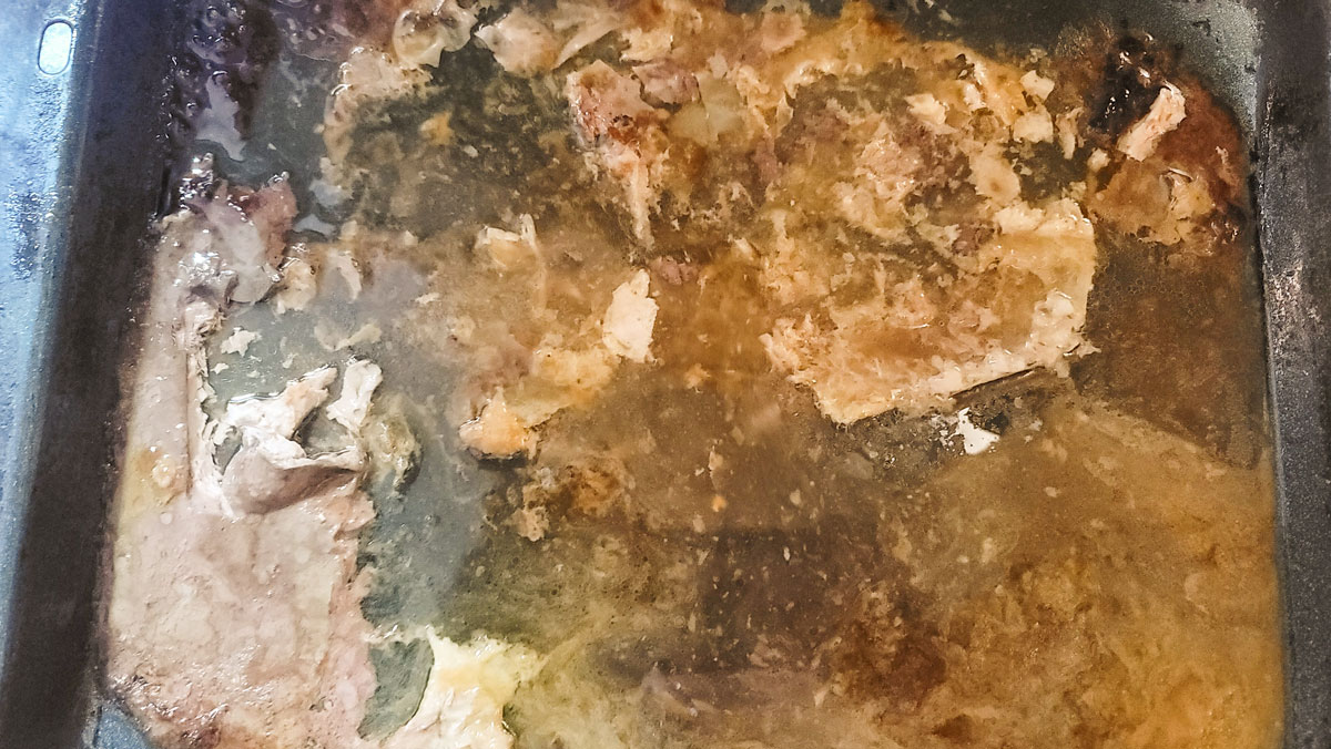 Roasting pan with juices in it. 