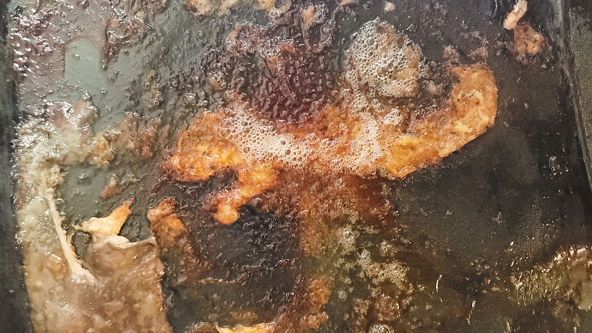 Browned drippings in the roasting pan.