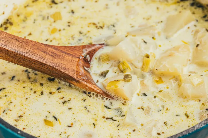 A wooden spoon in a bowl Potato Chowder with Hakurei Turnips