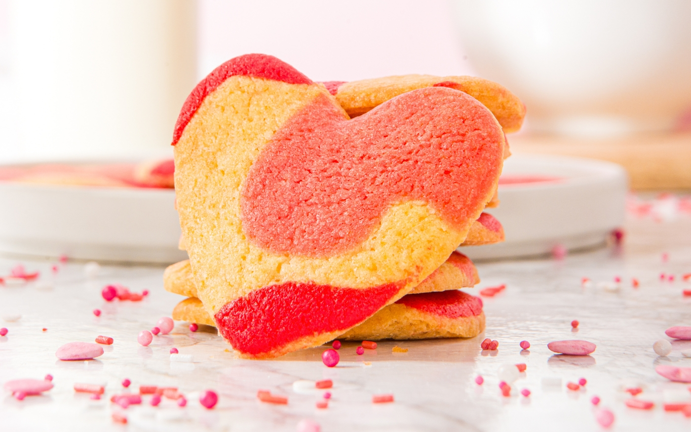 A Heart-Shaped Valentine Cookie in front of stacked cookies.