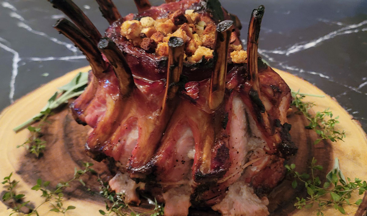 Stuffed pork crown roast in a wooden board.