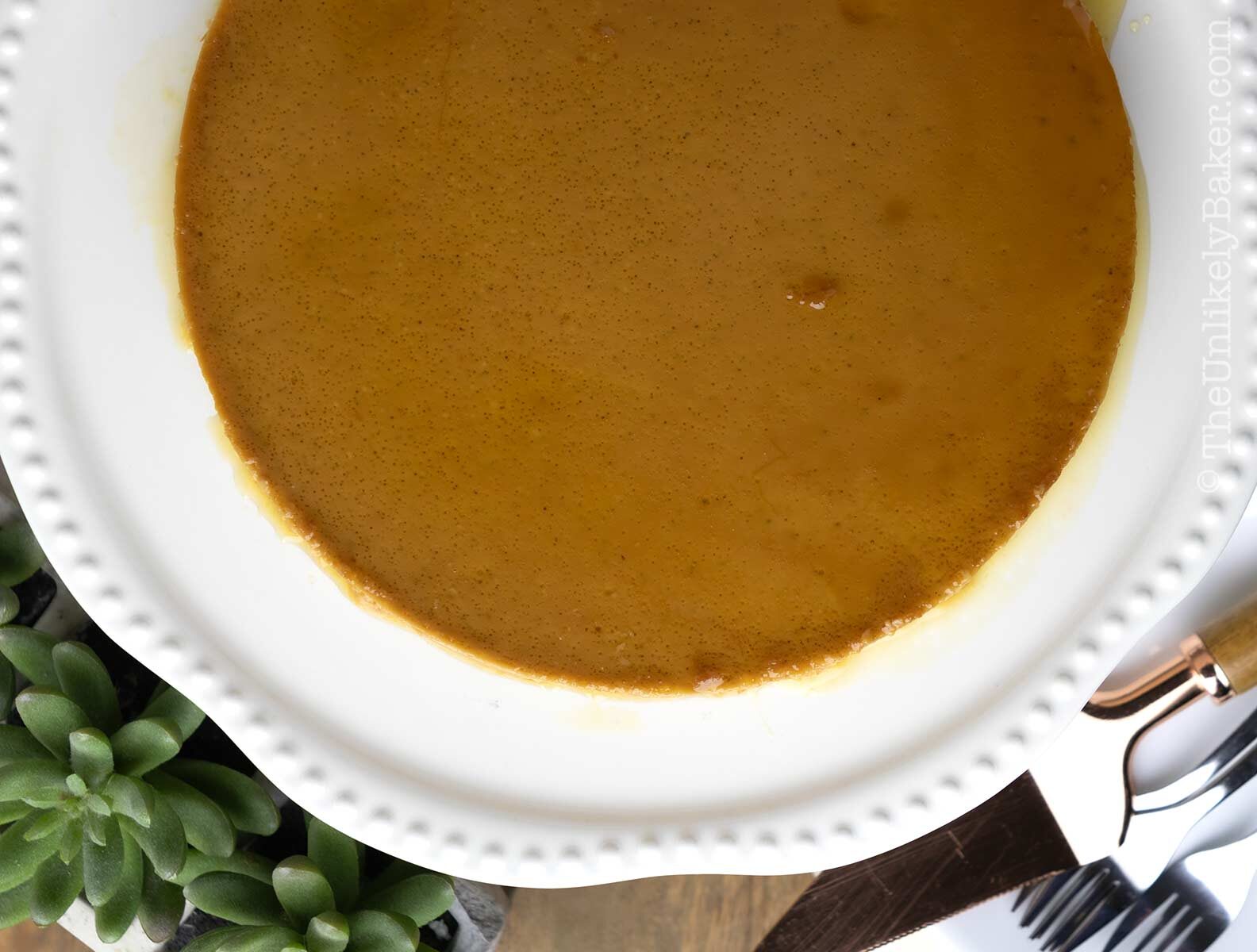 Dulce du leche flan on a white platter.