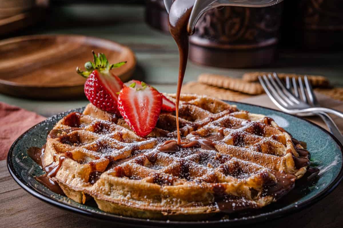 We love waffles, pancakes, and French toast. Sometimes it's hard to decide which one is the best. We have decided that it's all about the mood we're in and they can all be great. However, we are maybe vaulting this waffle into the current lead! We love Nutella and Biscoff cookies so much that they deserve to be used together in this amazing recipe for Biscoff Cinnamon Waffles with Nutella Cream.


