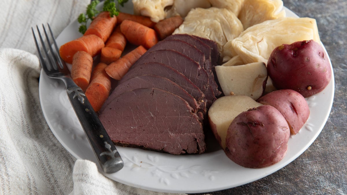 Close up of venison and cabbage with potatoes and carrots.