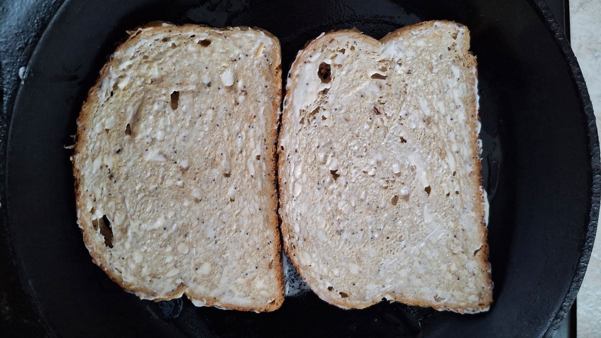 Toasting the bread in a skillet.