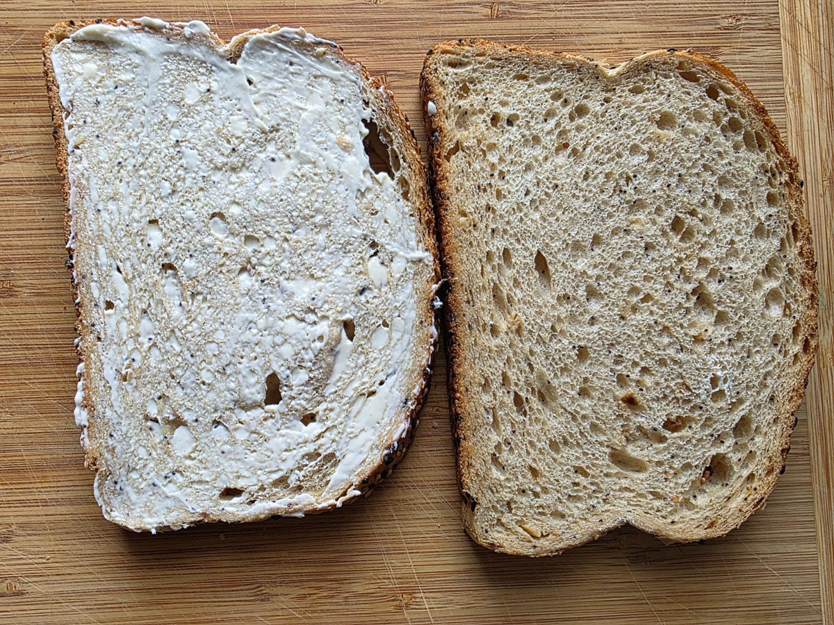 Mayonnaise spread onto a piece of bread.