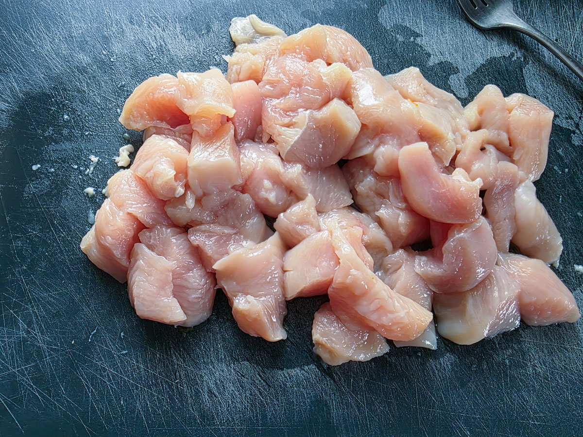 Chicken cut into bite sized pieces.