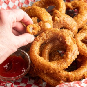 Bite shot of a perfectly crispy onion ring.