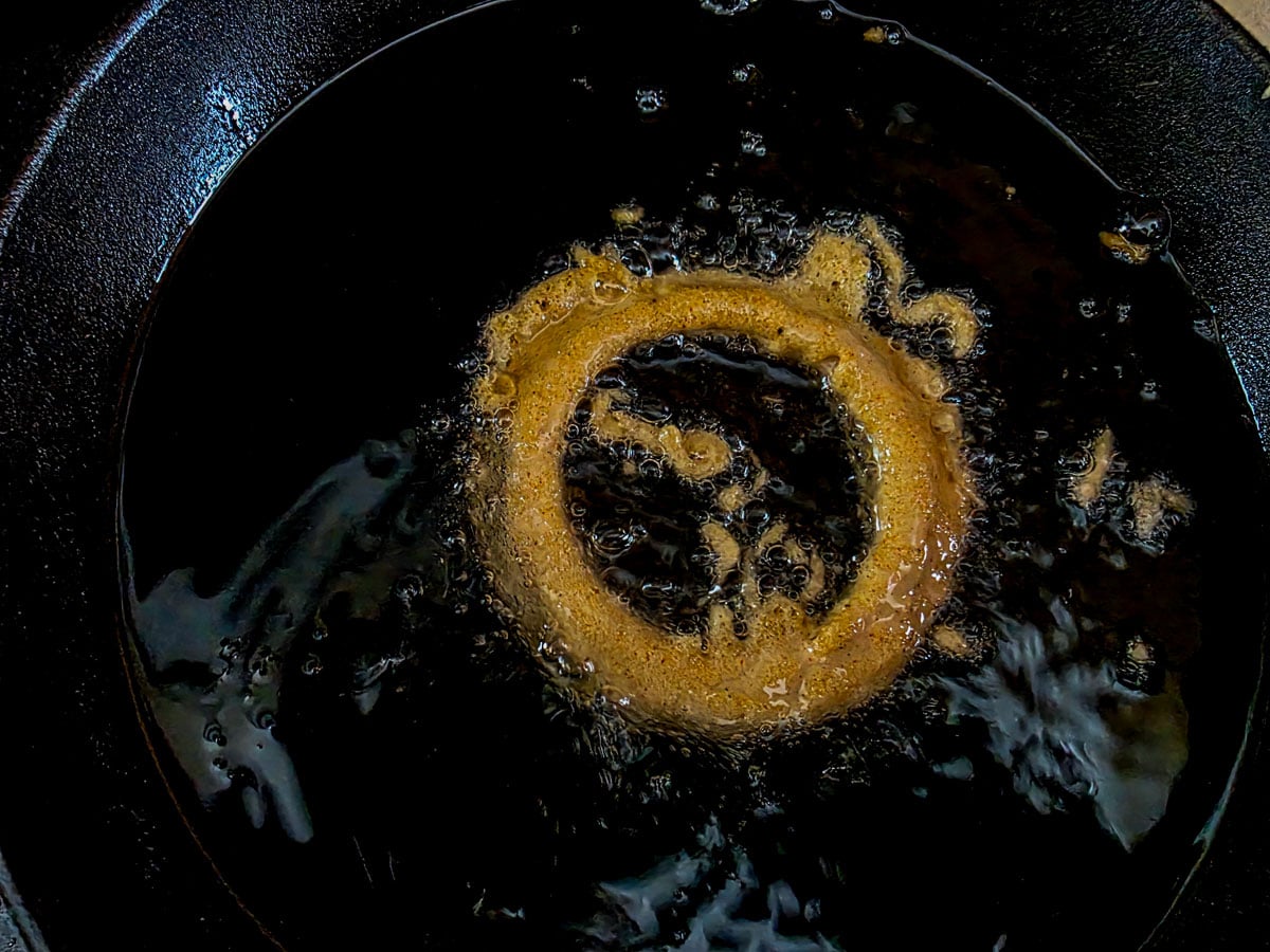 Frying onion ring in oil.