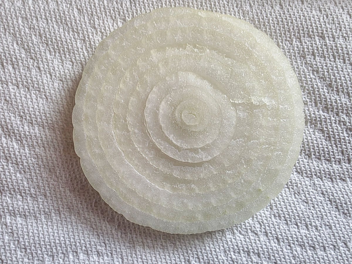Thickly slice onion on a paper towel.