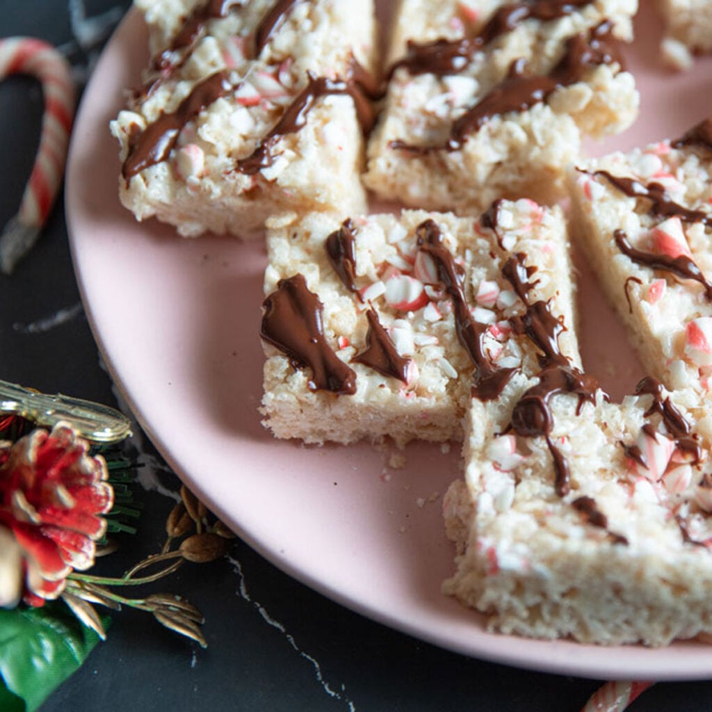 Close up of peppermint rice krispies on a pink plate.