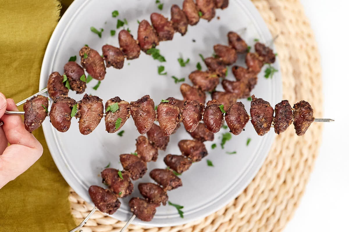 A plate of Grilled Chicken Heart Skewers.