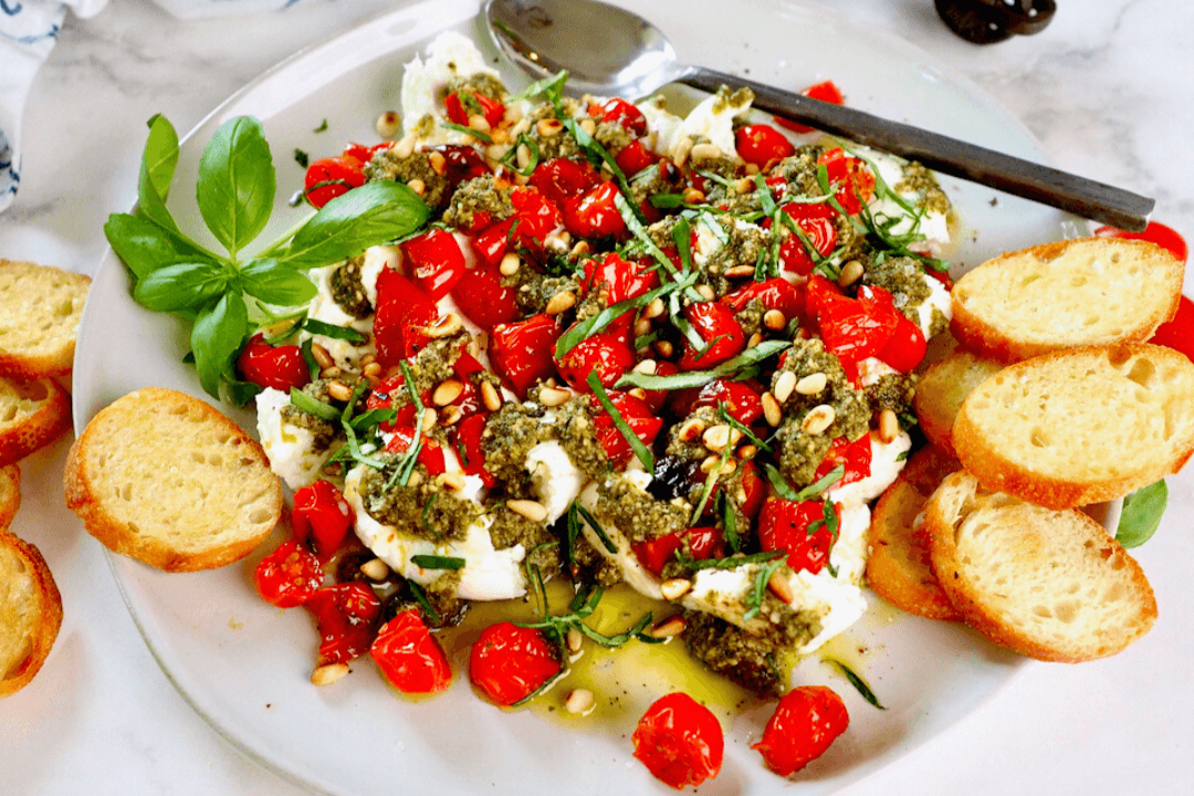 Easy Pesto Appetizer Recipe with Burrata and Roasted Tomatoes on a plate.