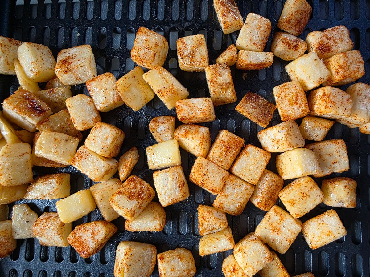 Hash browns arranged in the air fryer basket.