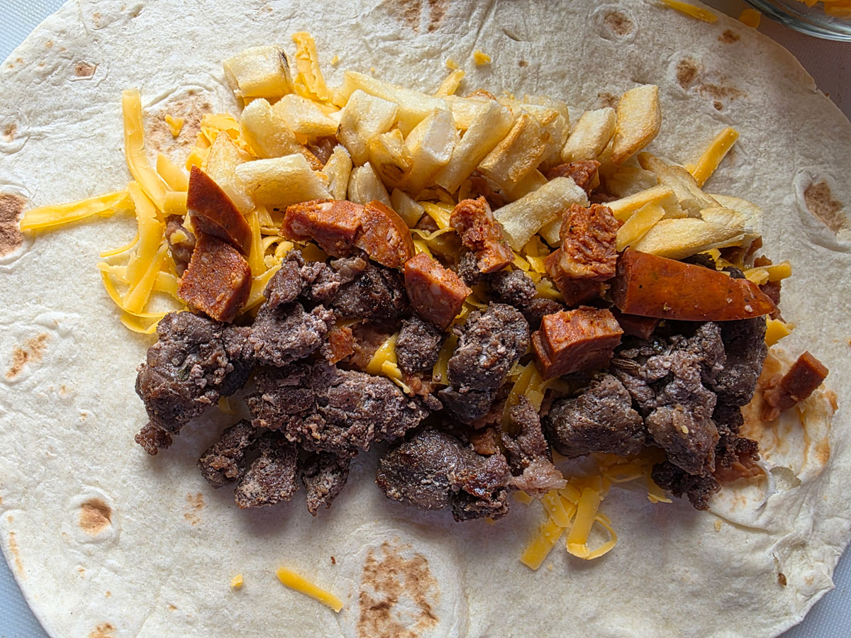 Chorizo and potatoes added to the tortilla shell.