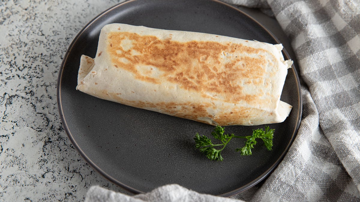 Golden brown burritos on a gray plate.