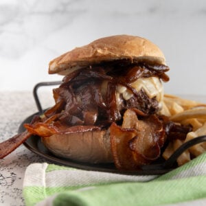 Caramelized onion burger on a metal tray.