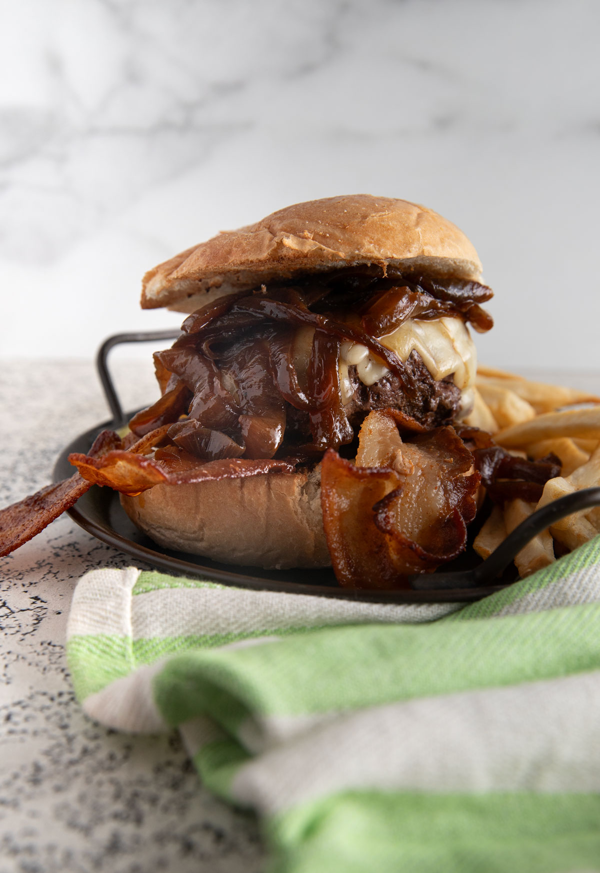 Onion burger on a black plate. 