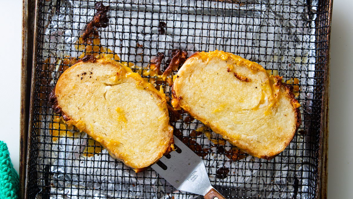 Flipping the sandwich on the air-fryer basket.