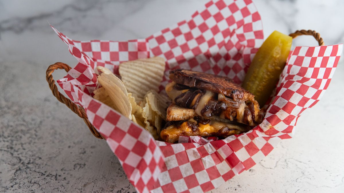 Caramelized onion grilled cheese sandwich in a  basket