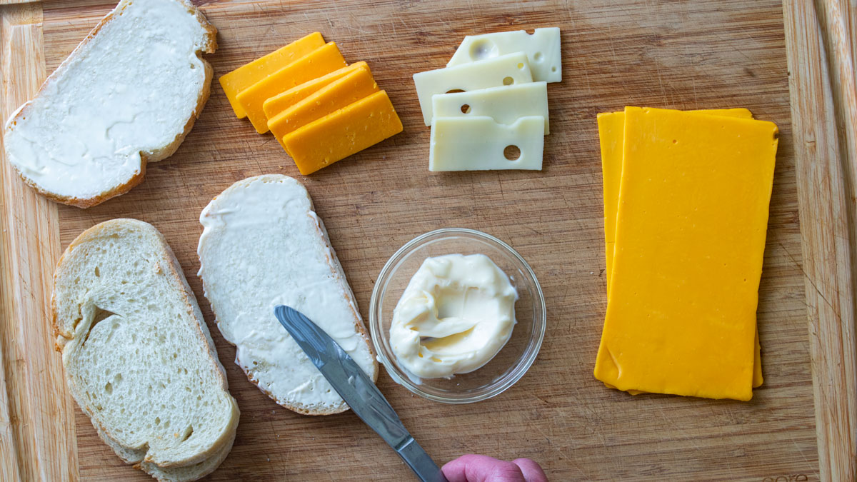 Mayonnaise spread on one side of the bread.