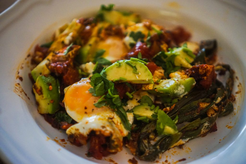 Spicy Shakshuka with Green Onion, Goat Cheese, & Avocado
