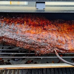 Beef brisket on grill racks.
