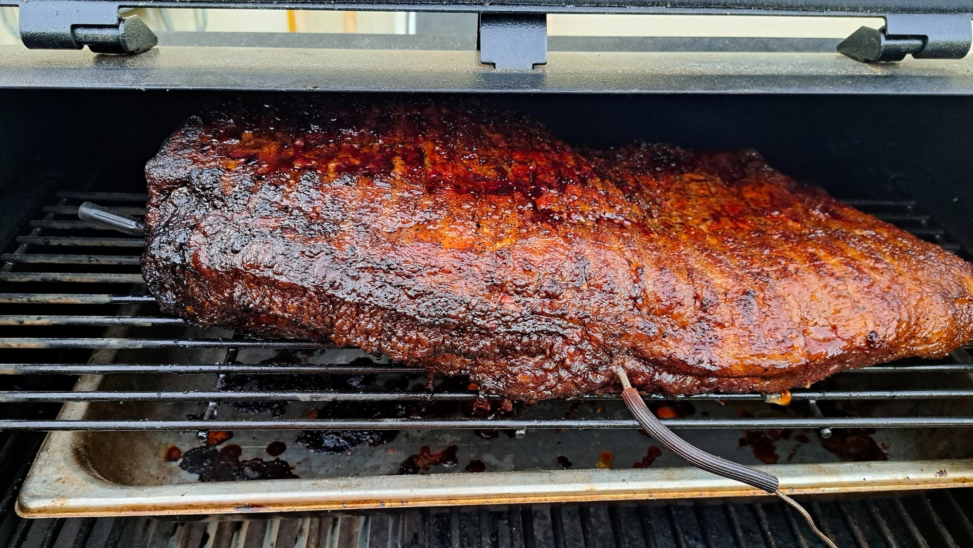 Beef brisket on grill racks.