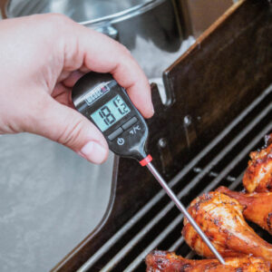 Meat thermomter testing temperature of chicken legs.