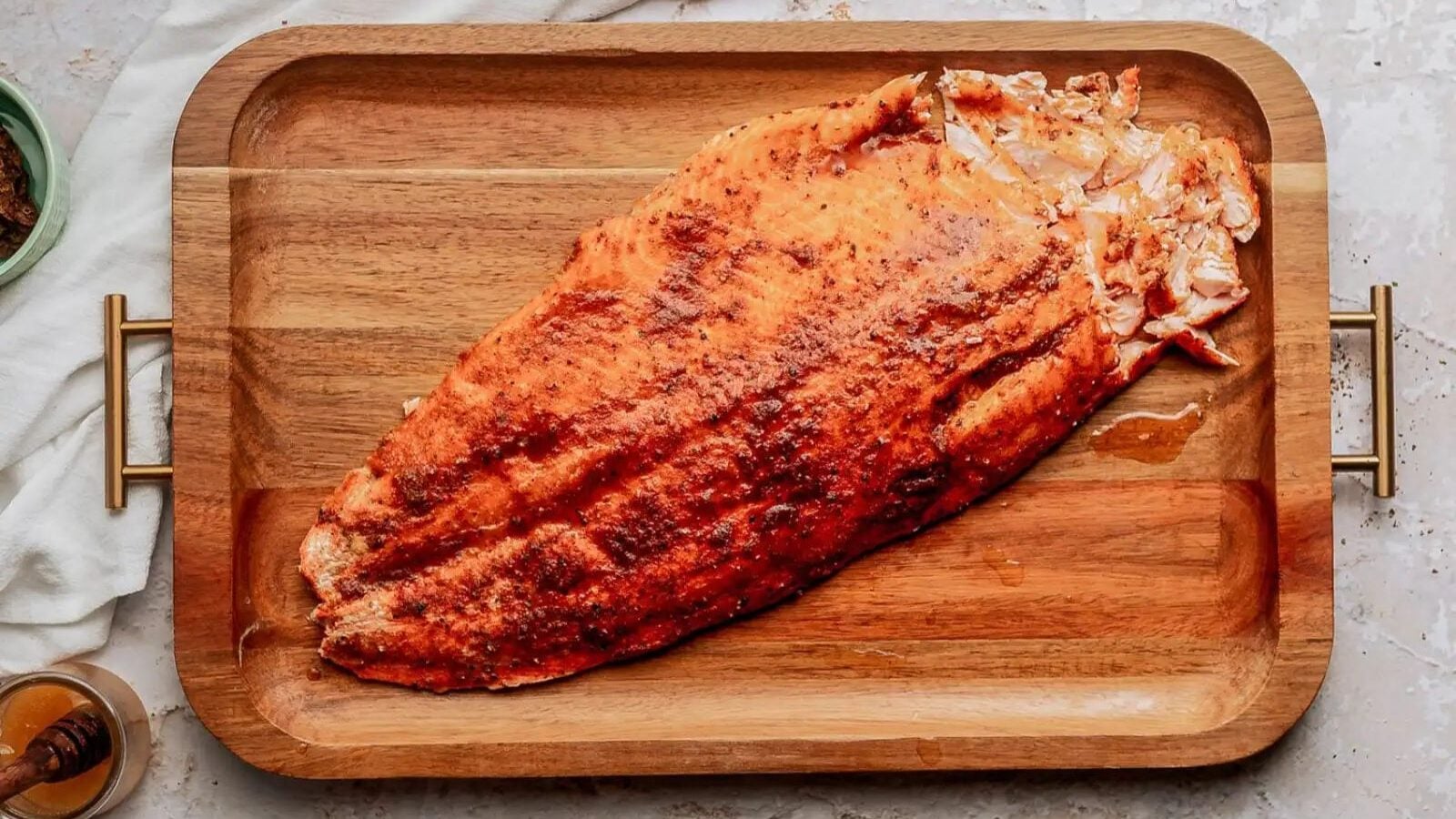 Honey chipotle salmon on a wooden board.