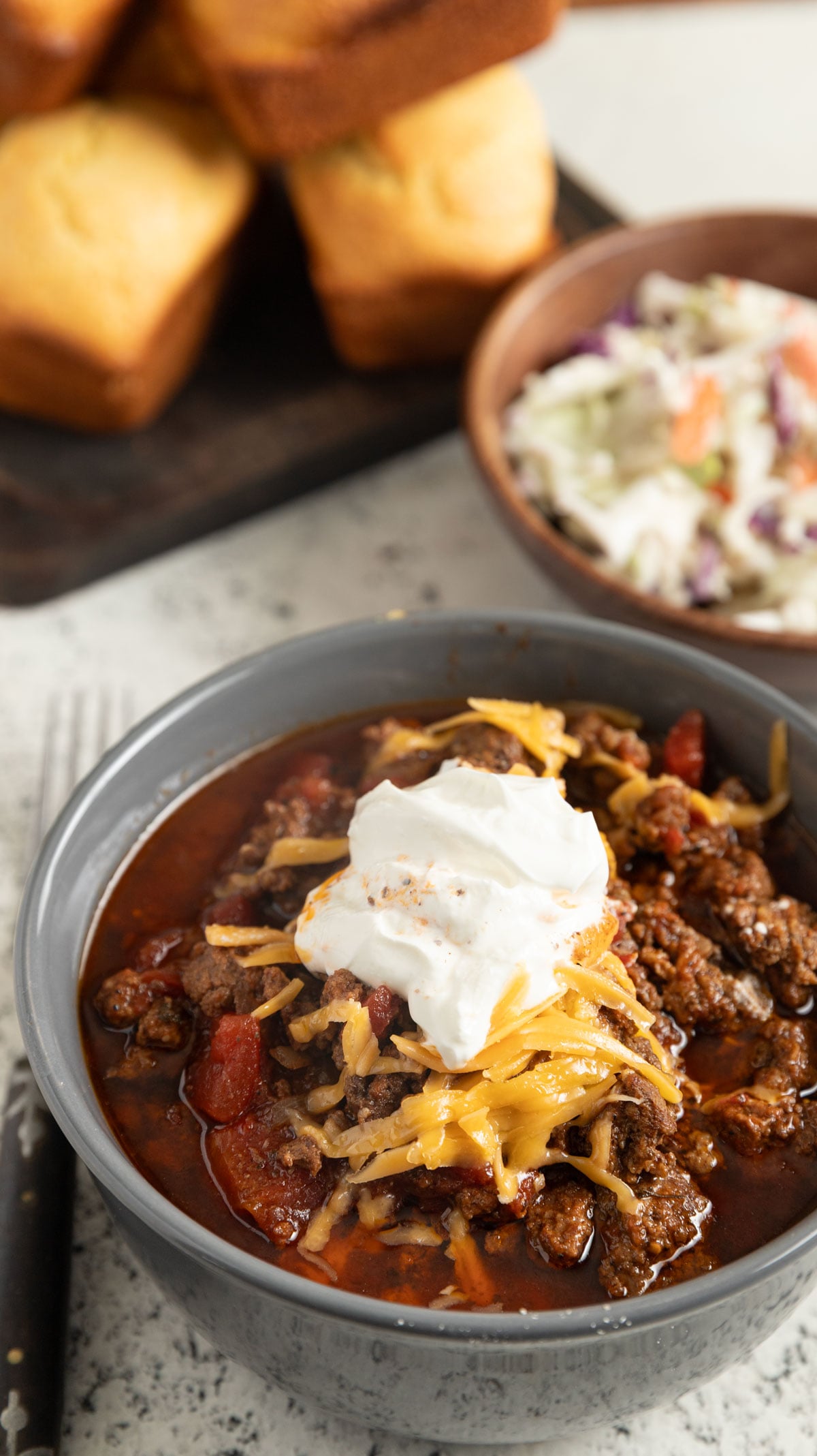 LBJs Pedernales River Chili in a bowl with toppings.