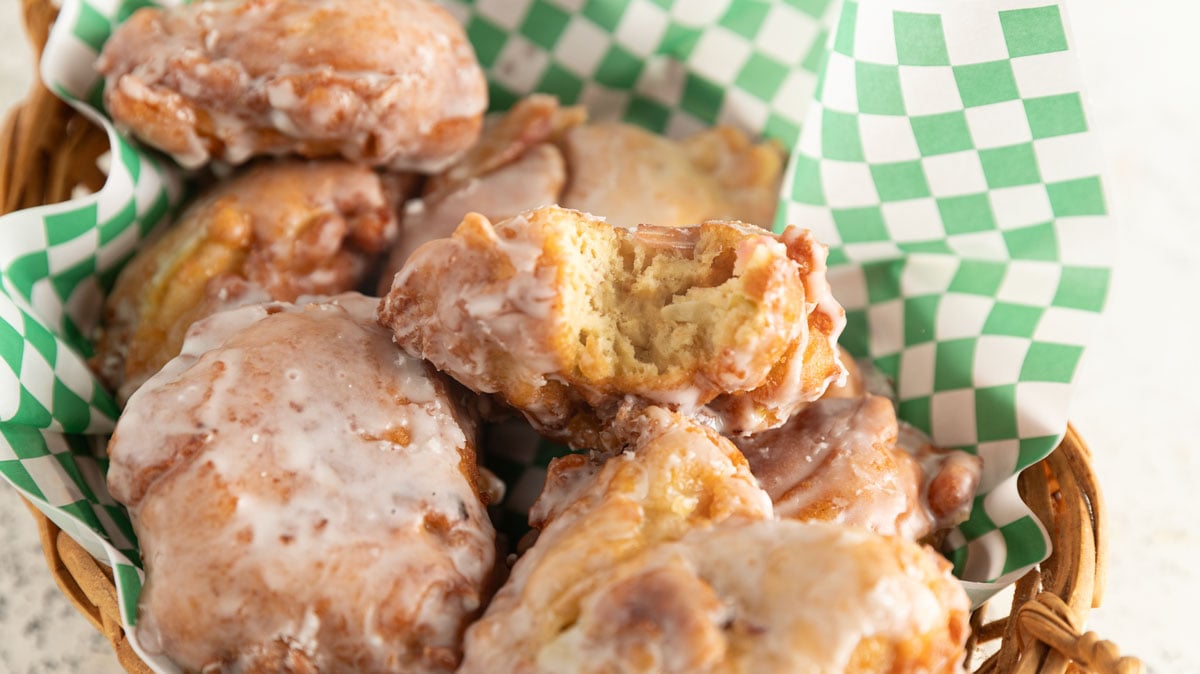Apple frittes in a basket with green and white checked paper.