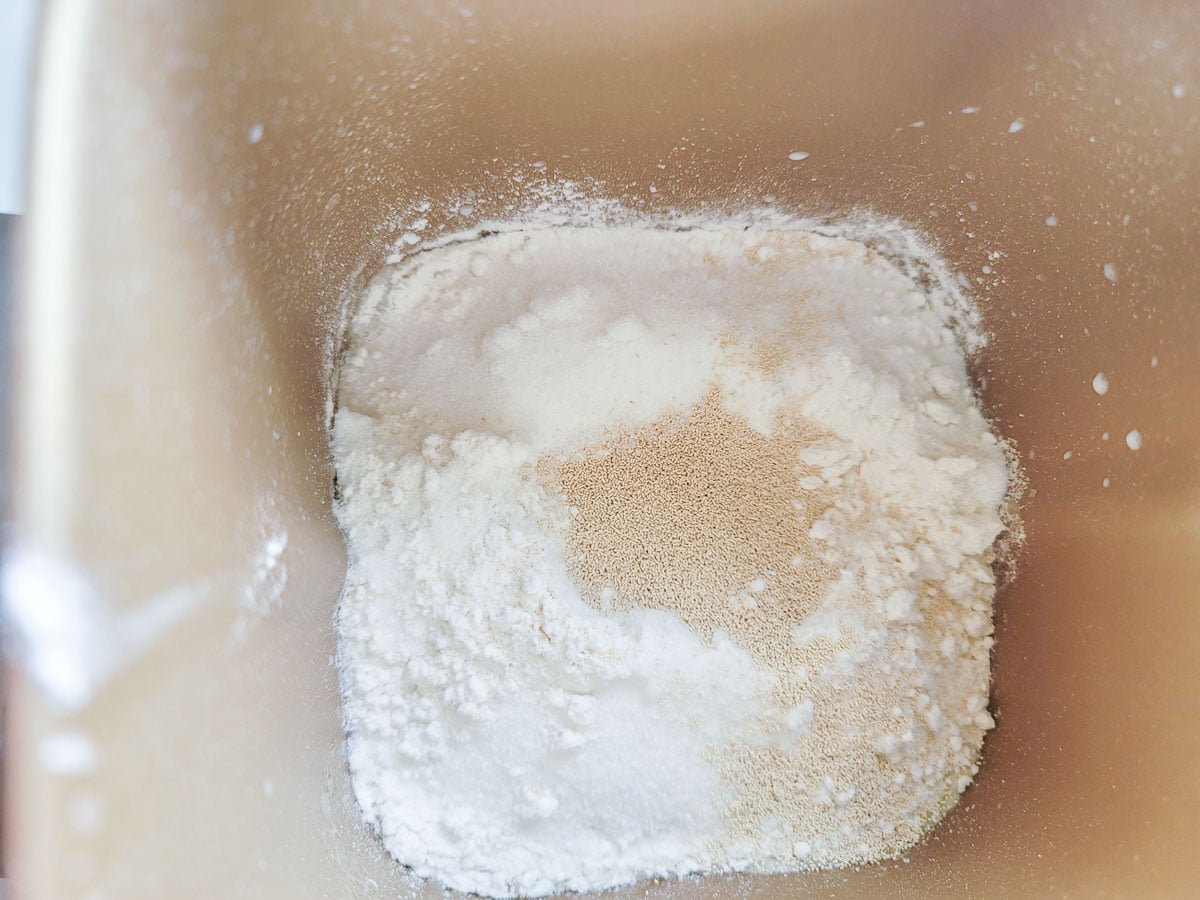 Yeast added to hole made in the center of the flour.