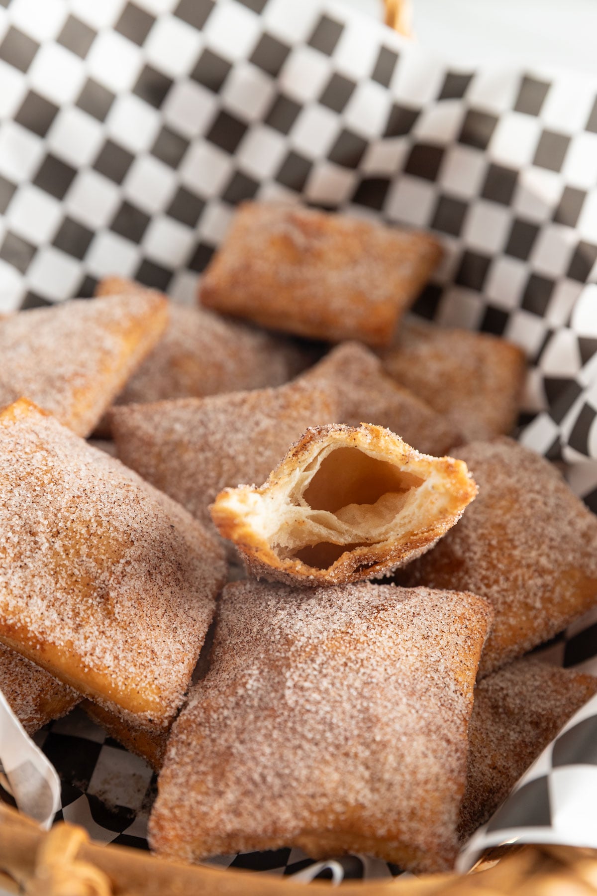 Sopapillas in a basket with cinnamon sugar topping.